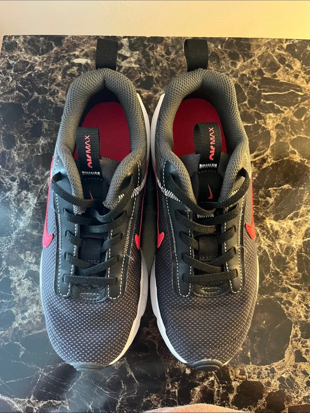 Nike Kids Black Sneakers with Red Swoosh and White Air Sole